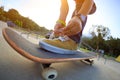 Woman skateboard tying shoelace at skatepark