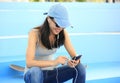 Woman skateboarder sit on skatepark stairs listening music Royalty Free Stock Photo