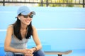 Woman skateboarder sit on skatepark stairs listening music Royalty Free Stock Photo