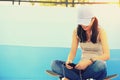 Woman skateboarder sit on skatepark stairs listening music Royalty Free Stock Photo