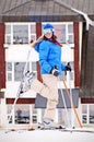 Woman in ski with hotel at the background Royalty Free Stock Photo