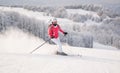 Young woman skier skiing fast downhill on ski slope