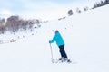 A woman skier slides down the mountain over white snow in a sports tourist base Turquoise Katun. Seasonal sports