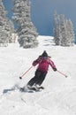 Woman Skiing Down Snow Covered Slope