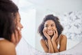 Woman, skin and mirror in the bathroom with glow in the morning for facial treatment at home. Model, skincare and beauty