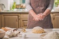 Woman slap his hands above dough closeup. Baker finishing his bakery, shake flour from his hands, free space for text.