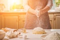 Woman slap his hands above dough closeup. Baker finishing his bakery, shake flour from his hands, free space for text.