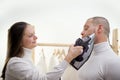 wife forces husband to iron clothes Woman slapping her boyfriend. isolated on a white background Royalty Free Stock Photo