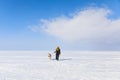 Woman with sled dog on the frozen bay Royalty Free Stock Photo