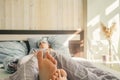 Woman sleep in bed. Focus on feet