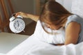 Woman sleep on the bed turns off the alarm clock wake up at the morning, Selective focus. Royalty Free Stock Photo