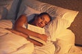 Woman, sleep and book in room and light, dreaming female person or night lamp for story and novel. Relax, hobby and Royalty Free Stock Photo