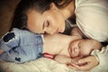 Woman sleep with infant child boy in jeans Royalty Free Stock Photo