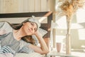 Woman with morning coffee in bed