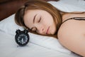 Woman sleeping with alarm clock