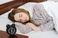 Woman sleeping with alarm clock Royalty Free Stock Photo