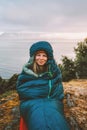 Woman in sleeping bag bivouac outdoor camping gear girl hiking in mountains active travel vacations