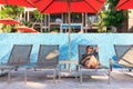 Woman sleeping on beach bed in luxury resort. Royalty Free Stock Photo