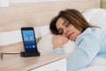 Woman Sleeping On Bed With Alarm On Mobile Phone Royalty Free Stock Photo