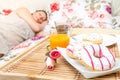 Woman sleeping in the bed with breakfast tray near her Royalty Free Stock Photo