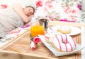 A woman sleeping in the bed with breakfast tray near her Royalty Free Stock Photo