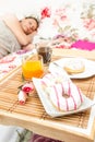 Woman sleeping in the bed with breakfast tray near her Royalty Free Stock Photo