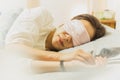 Woman sleeping on bed with eye mask on. Royalty Free Stock Photo