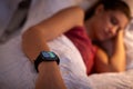 Woman Sleeping In Bed With Focus On Smart Watch She Is Wearing Royalty Free Stock Photo