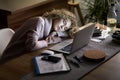 Woman sleeping on the desk in front of the laptop Royalty Free Stock Photo