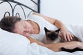 Woman sleeping in embrace with cat Royalty Free Stock Photo