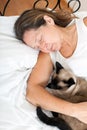 Woman sleeping in embrace with cat Royalty Free Stock Photo