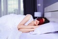 Woman sleeping with eye mask on bed Royalty Free Stock Photo