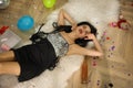 Woman sleeping on floor in messy room after New Year party, above view Royalty Free Stock Photo