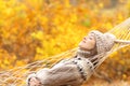 Woman sleeping on hammock in a forest in autumn Royalty Free Stock Photo