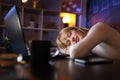 Woman sleeping at her desk while working overtime Royalty Free Stock Photo