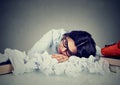 Woman sleeping at her disorganized desk