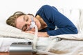 Woman sleeping on her side with CPAP machine in the foreground.