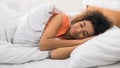 Woman sleeping, lying in bed comfortably and blissfully