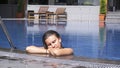 Woman sleeping and reposing in swimming pool