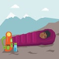 Woman sleeping in a sleeping bag in the mountains.