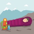 Woman sleeping in a sleeping bag in the mountains.