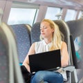 Woman sleeping while travelling by train.