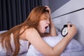 woman sleeping and wake up to turn off the alarm clock in morning Royalty Free Stock Photo