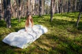 Woman sleeps on a mattress in the summer forest