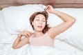 Woman sleeps relaxed on a large spacious bed at home or in a hotel