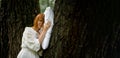 Woman sleeps soundly outdoors. She is lying on a pillow on a tree. Unity with nature, relaxation, recovery concept Royalty Free Stock Photo