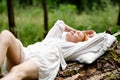 A woman sleeps in the woods on a pillow. Healthy, sound sleep concept. Rest, relaxation in nature