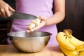 Woman slice ripe banana fruit