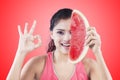 Woman with slice of watermelon on red background Royalty Free Stock Photo