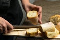 Woman sliced French fresh bread baguette with poolish, shallow d Royalty Free Stock Photo